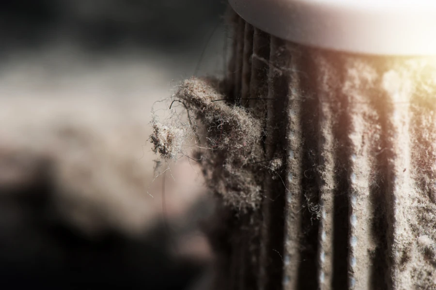 A close up of a dusty air filter.